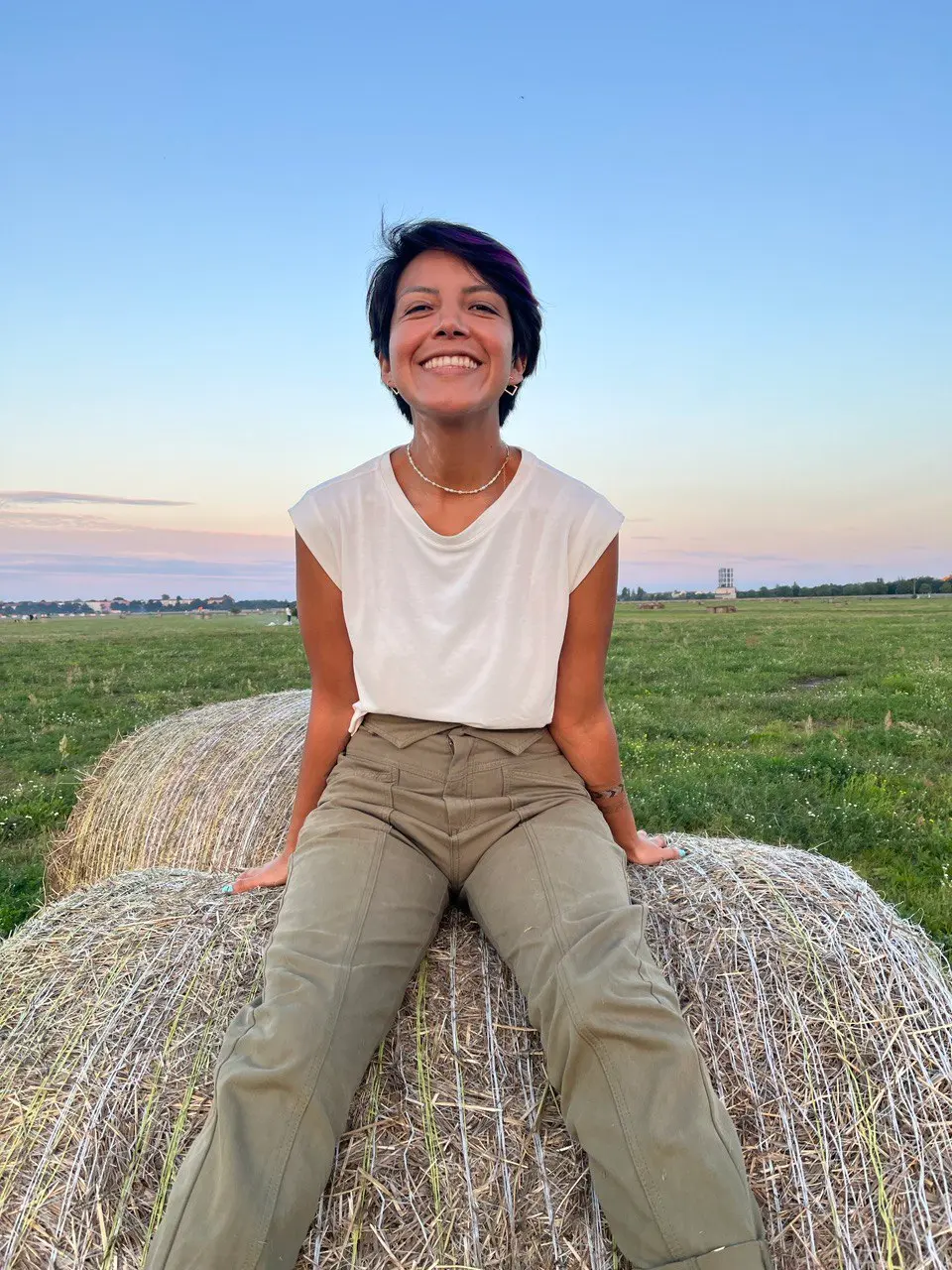 Me in a tipical sunset at Tempelhof. I'm sitting on top of a bale of hay.