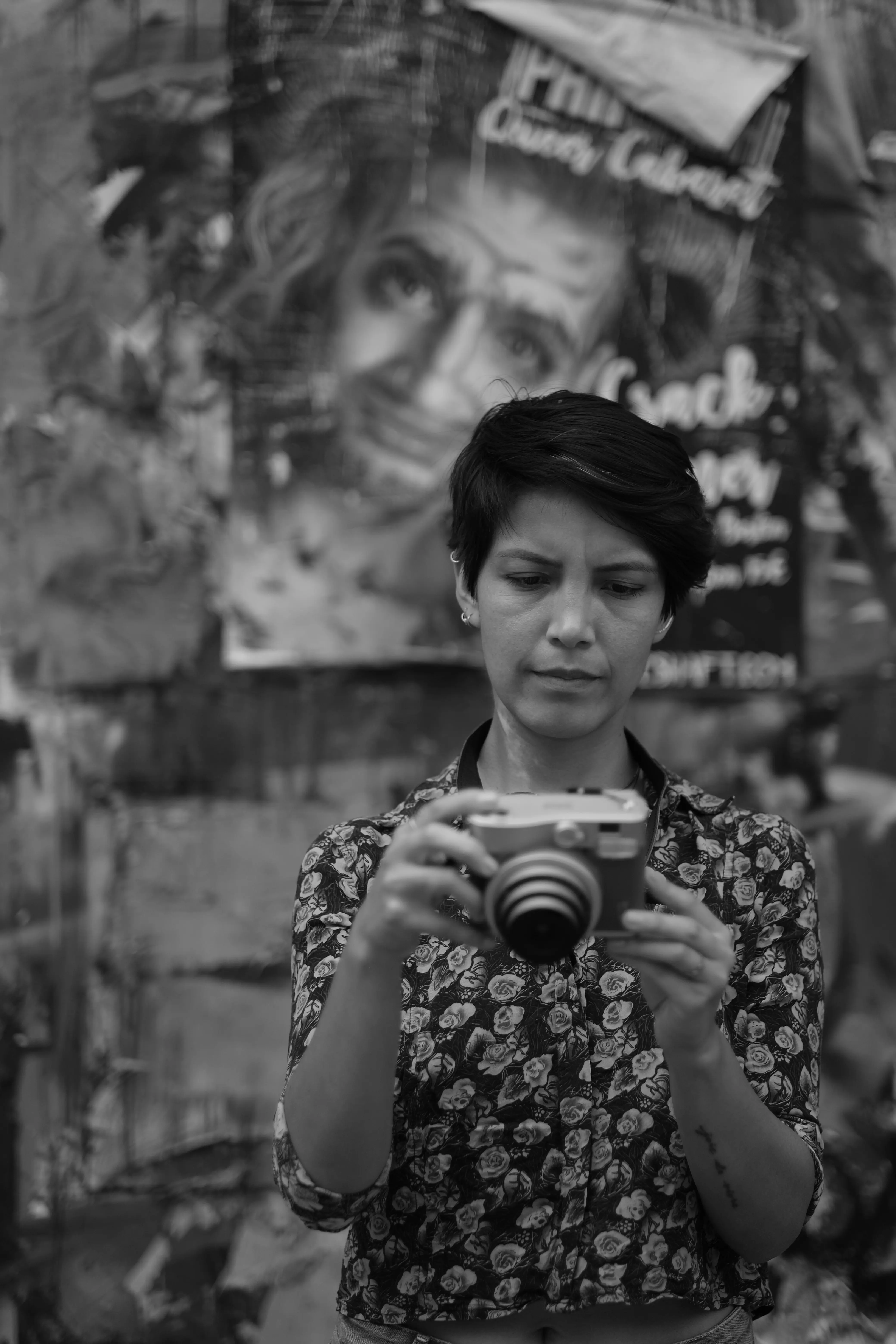 Photos of Ursula going on a walk, holding a instant camera, and exploring the city.