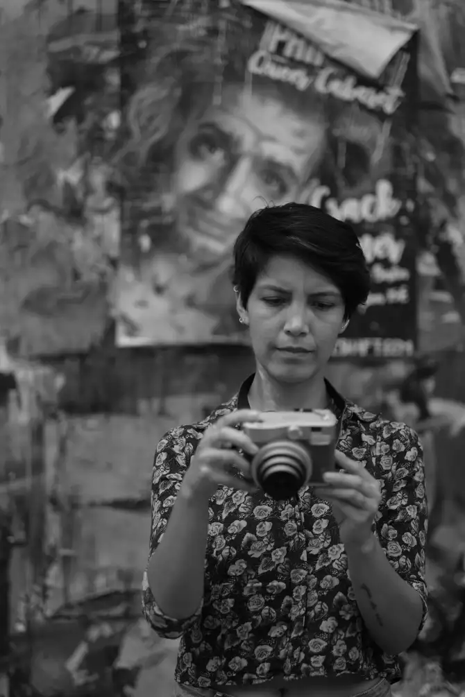 Photos of Ursula going on a walk, holding a instant camera, and exploring the city.